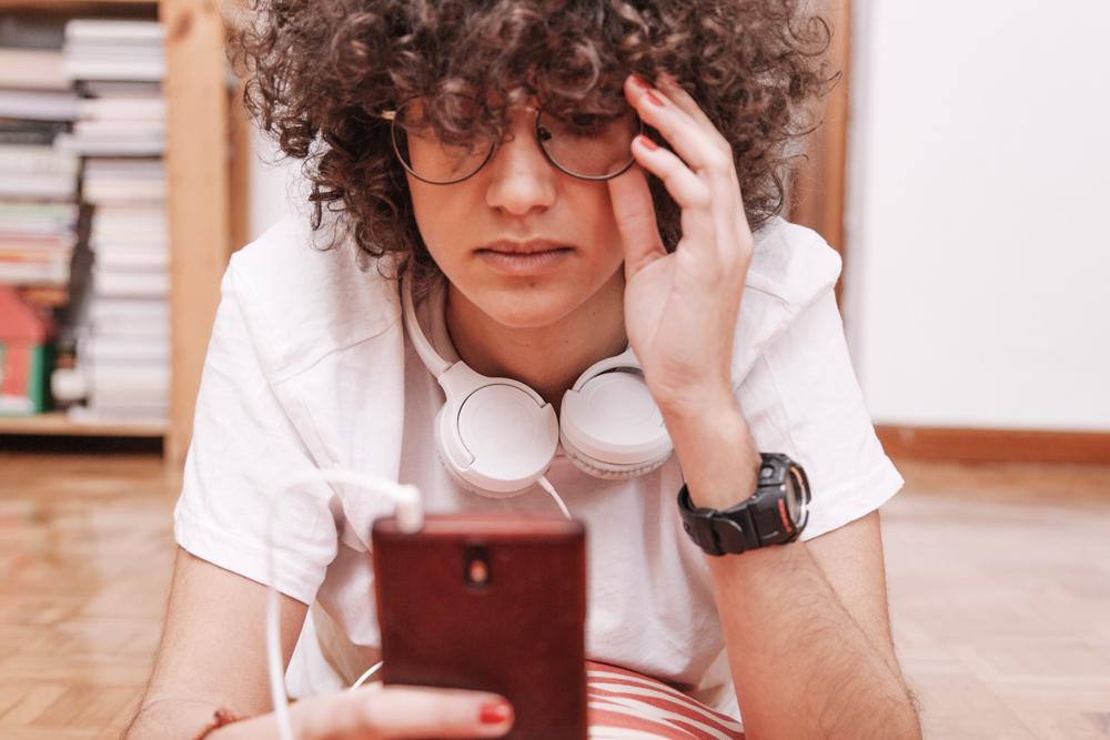 Chica joven viendo su teléfono móvil