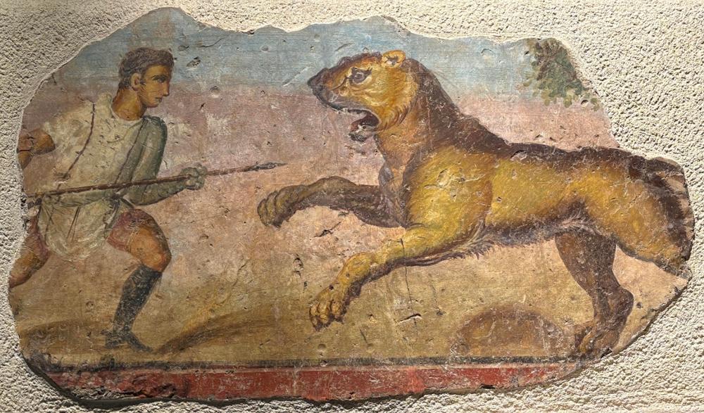 Pintura mural romana que muestra a un venator con un león. Crédito: Museo Nacional de Arte Romano (MNAR)